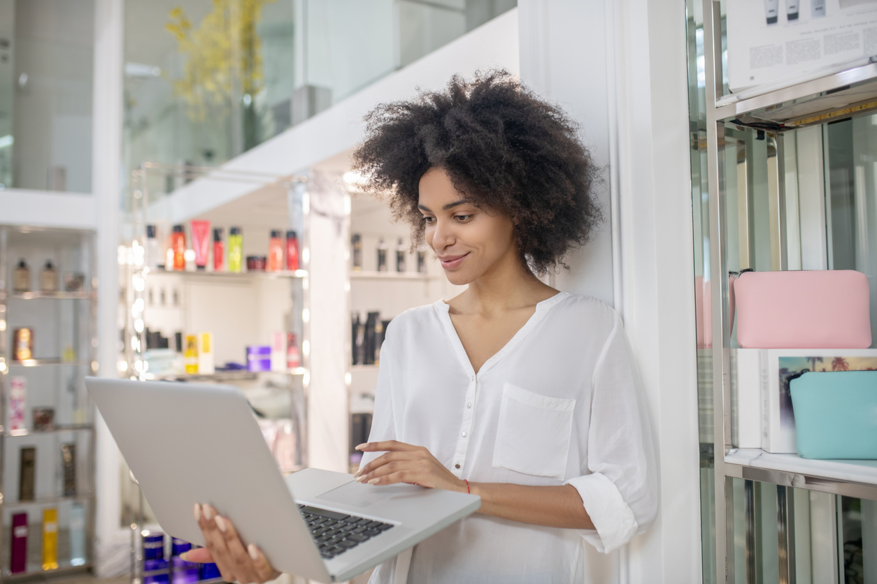 Salon owner using salon software on a laptop to manage bookings