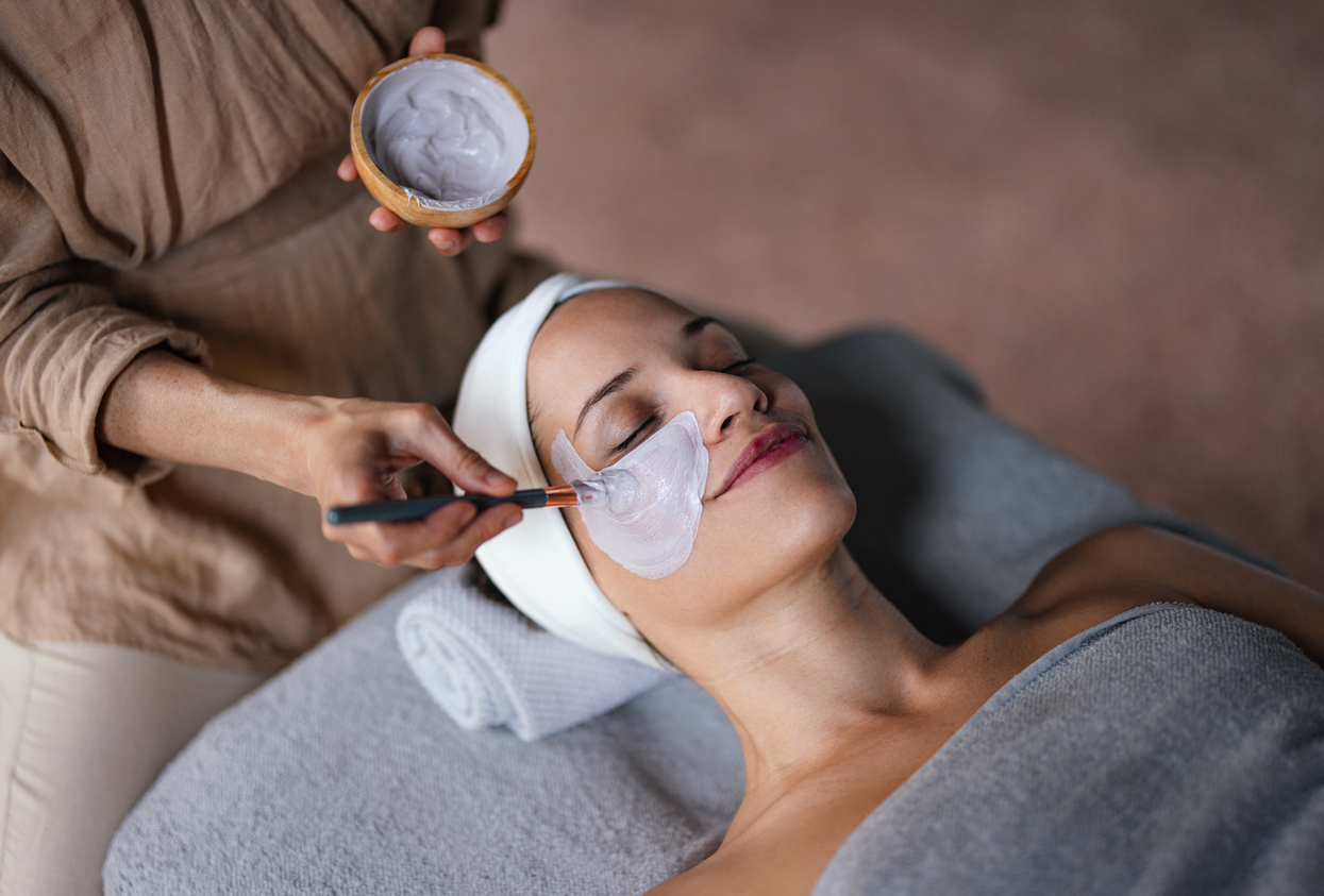 A woman receiving a relaxing facial treatment, reflecting the high-quality beauty services offered at Beauty Exposed Boutique.